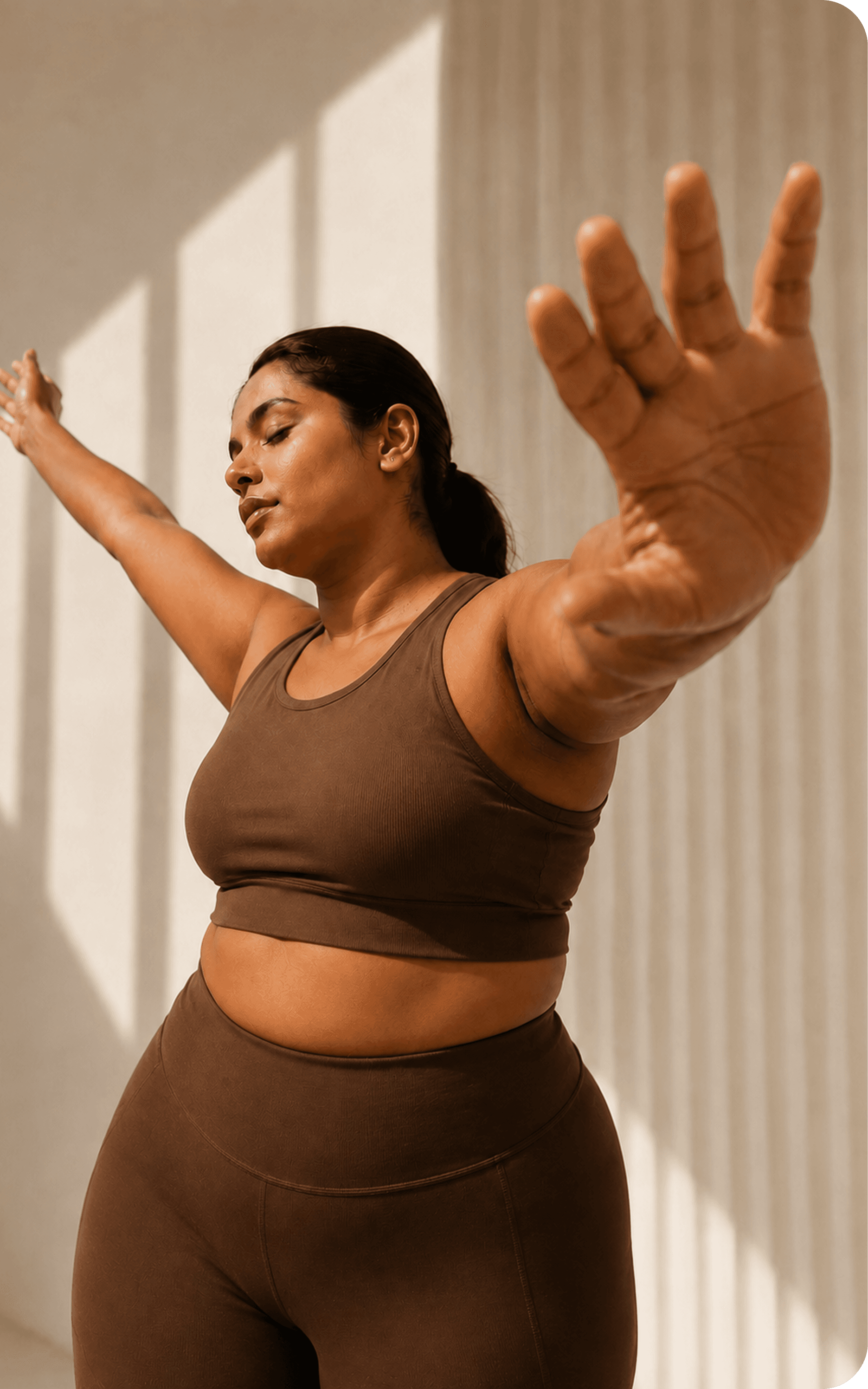 Woman stretching in sunlight during a wellness practice